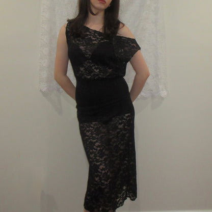 Black lace dress worn by a person against a neutral background