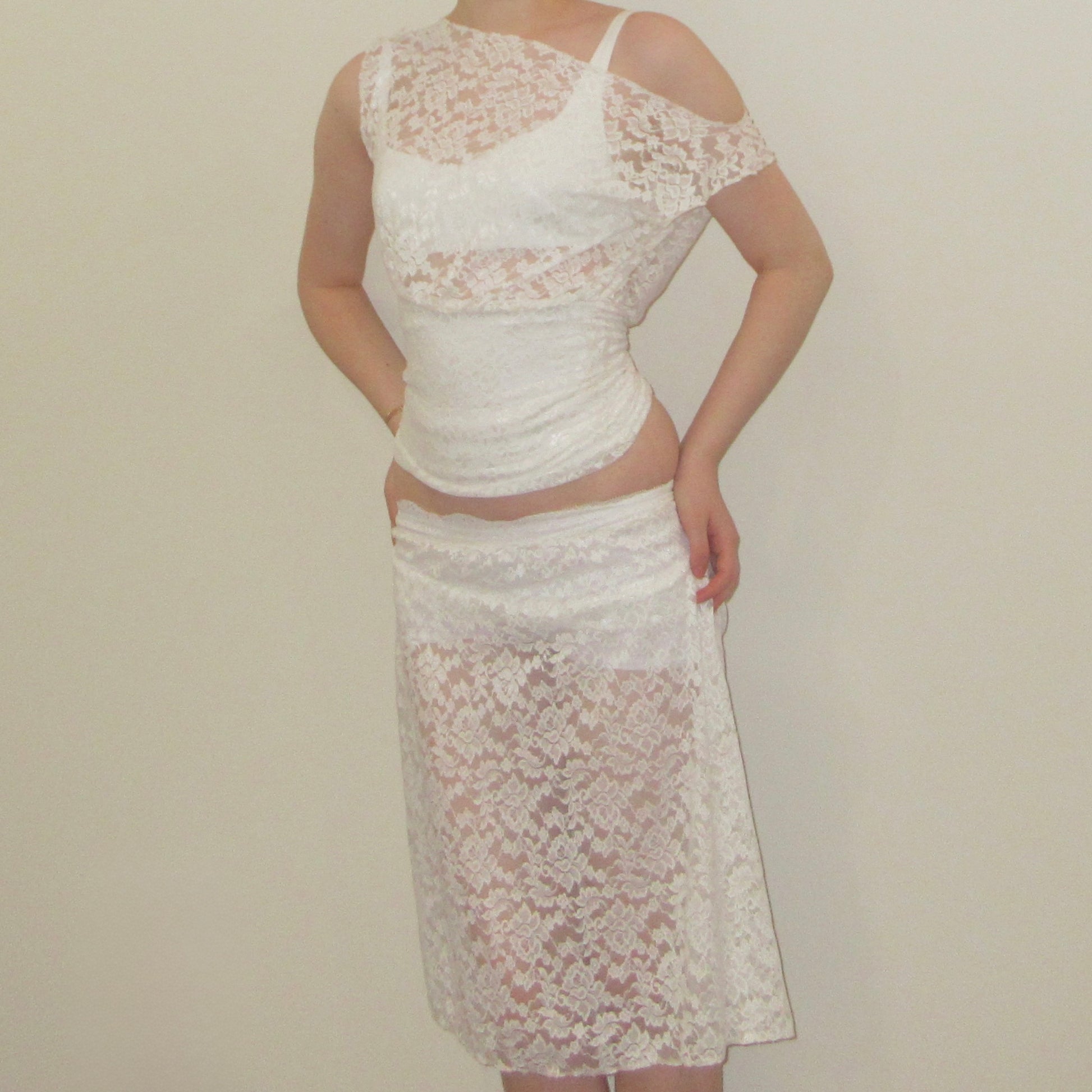 White lace top and skirt set on a plain background