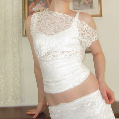 White lace dress worn by a person, with a neutral background