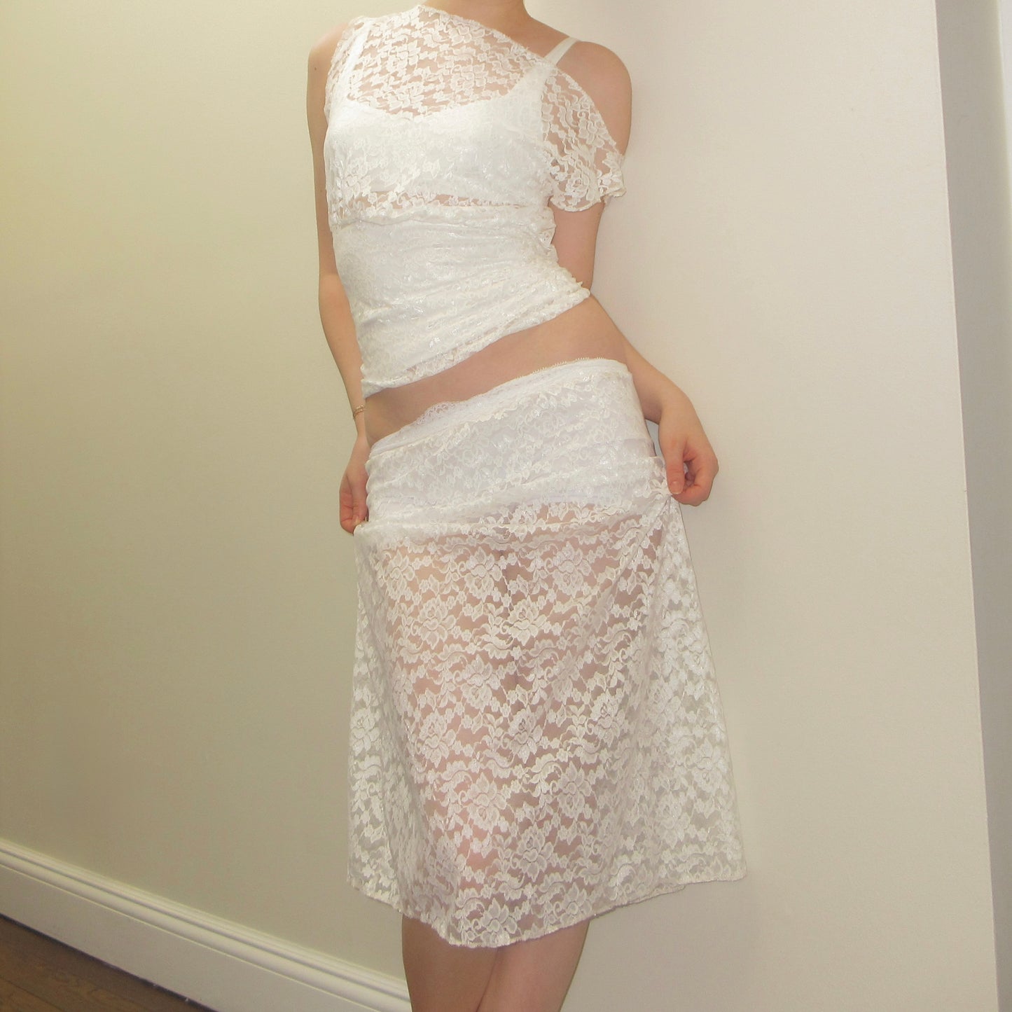 White lace outfit against a plain background