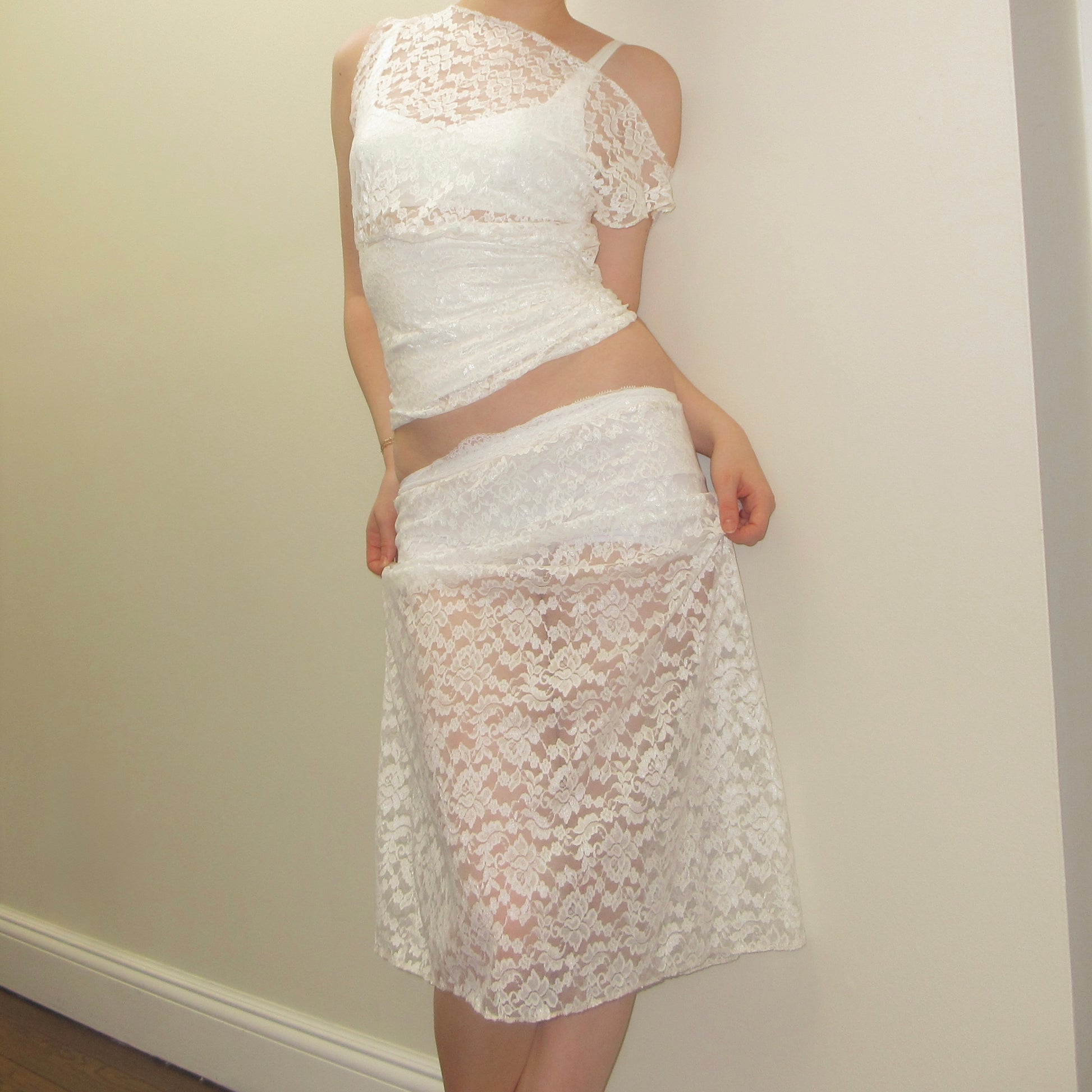 White lace outfit against a plain background