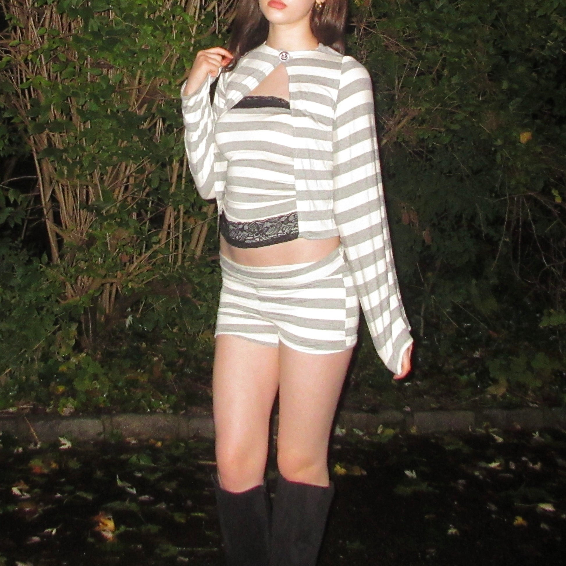 Person wearing a striped outfit with a dark background